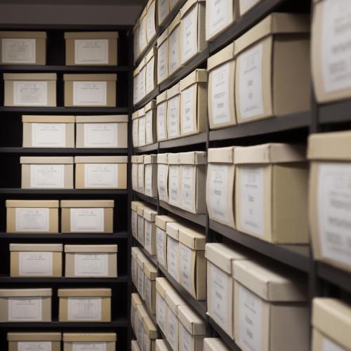 File boxes neatly and orderly stored away on shelves