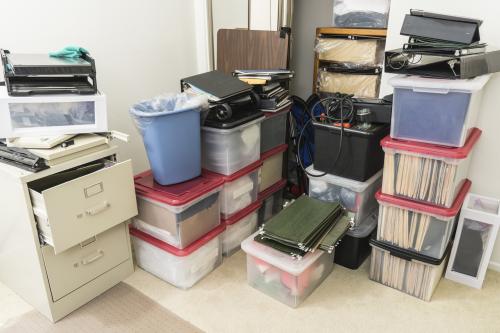 A cluttered and messy office space that is too small for its contents